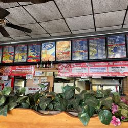 Milano's Pizza - Menu above the counter