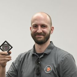 Challenge Coins 4 U - Bryan holds up his public awards challenge coin for excellence in safety.