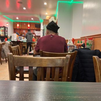 FeiLong Noodle King - a man sitting at a table in a restaurant - Chinese Near Me - Brooklyn, New York