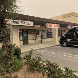 Outside of donut queen, located in shopping center.