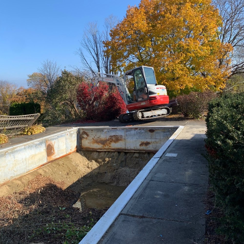 Jhs Landscape Construction - a construction vehicle on the side of a road - Landscaping Near Me - Littleton, Massachusetts