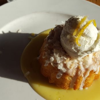 Limestone - Coconut bundt cake w/ coconut glaze, toasted coconut, lemon curd, whipped cream & candied lemon - Pizza Near Me - Lawrence, Kansas