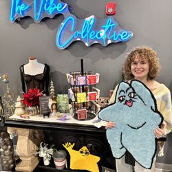 The Vibe Collective - Izze of Cheeky Monkey admiring her sweet rugs on Grand Opening day!!