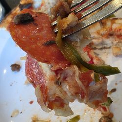 Lil' Cucci’s Pizzeria - Close-up of a piece of the pizza and a fork. All fresh quality ingredients.