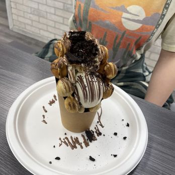 Milano Ice Cream - a chocolate covered cone with a chocolate drizzle on top - Ice Cream & Frozen Yogurt Near Me - Cincinnati, Ohio