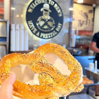 Ben's Soft Pretzels - a hand holding a pretzel - Pretzels Near Me - St. Augustine, Florida
