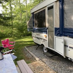 Red Gates Rv Park - Our campsite-very clean-electricity and hook ups available. Water feature is just beyond the trees.
