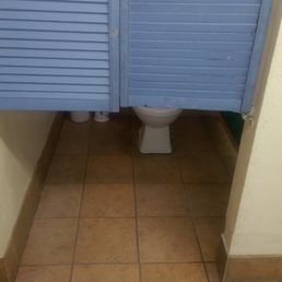 The door to the only men's  bathroom stall.