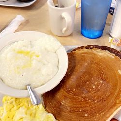 2 Pancakes & Bacon Grits Scrambled Eggs Coffee & Water.