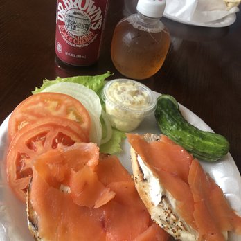 The Bagel Express - Nova Scotia Platter on an everything bagel with a side of potato salad and a pickle. - Bagels Near Me - Kendall, Florida The Bagel Express - Nova Scotia Platter on an everything bagel with a side of potato salad and a pickle. - Bagels Near Me - Kendall, Florida