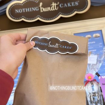 Nothing Bundt Cakes - a person holding a brown paper bag - Bakeries Near Me - Tyler, Texas