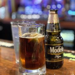 Cuates Grill - Negra Modelo in a chilled mug with a lime