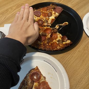 Round Table Pizza - Montague's Meat Marvel Medium Pizza compared to hand - Pizza Near Me - Fullerton, California