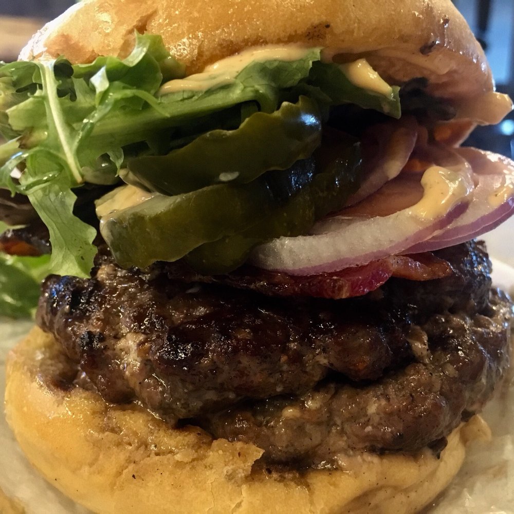 Cubby's - The Dragonslayer ($9.99) - Double Top Sirloin, Bleu Cheese, Smoked Bacon, Tomatoes, Pickles, Mixed Greens, & Buffalo Sauce - New American Near Me - Provo, Utah Cubby's - The Dragonslayer ($9.99) - Double Top Sirloin, Bleu Cheese, Smoked Bacon, Tomatoes, Pickles, Mixed Greens, & Buffalo Sauce - New American Near Me - Provo, Utah