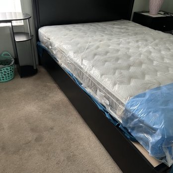 Adjectives Market - Angle photo: Queen size bedroom set with mattress and plastic cover , wooden frame , footend drawers - Furniture Stores Near Me - Altamonte Springs, Florida