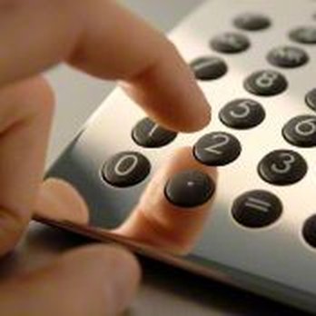 Flooring By Design - a person using a calculator - Flooring Near Me - Grandville, Michigan Flooring By Design - a person using a calculator - Flooring Near Me - Grandville, Michigan