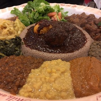 Blue Nile - Vegetarian combo with doro wat (center) and beef tibs (far right). - Ethiopian Near Me - Houston, Texas