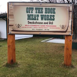 Off The Hook Meat Works - This sign is in front of a person's house. The shop is on its left