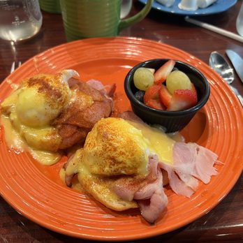 Unbridled Cafe - a plate of eggs benedict with ham and fruit - Breakfast & Brunch Near Me - East Amherst, New York Unbridled Cafe - a plate of eggs benedict with ham and fruit - Breakfast & Brunch Near Me - East Amherst, New York