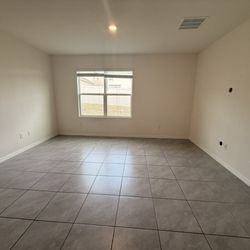 Multi Choice Realty - Professional cleaned living room after move out. This is where the tv mount was which we accept the $300 deduction for.
