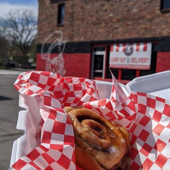Greek's Pizzeria - a hand holding a hot dog - Pizza Near Me - Indianapolis, Indiana
