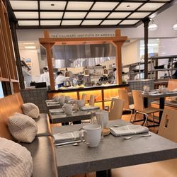 Savor - The Culinary Institute of America. Dining area with the kitchen in the background.