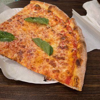 Lucia Pizza - Really good slice.  Could do without the giant leaves on it. - Pizza Near Me - New York, New York