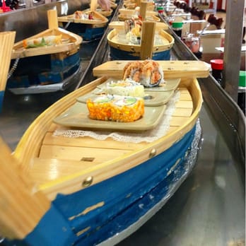 Kobe Sushi Buffet - Chef placing Sushi on the boats as they make their way around - Sushi Bars Near Me - Modesto, California Kobe Sushi Buffet - Chef placing Sushi on the boats as they make their way around - Sushi Bars Near Me - Modesto, California