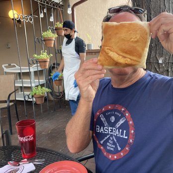 Tomasita's - Sopapillas as big as his face!!! - New Mexican Cuisine Near Me - Santa Fe, New Mexico