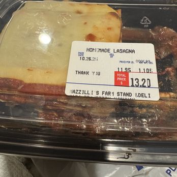 Mazzilli Farm Stand - A clear plastic food container contains homemade lasagna with a cheese topping, labeled from a food stand, with a total price of $13.20. - Fruits & Veggies Near Me - Wareham, Massachusetts