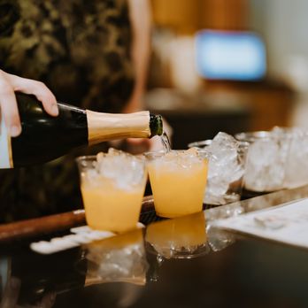 Wolfe Heights Estates and Winery - a woman pouring a glass of champagne - Venues & Event Spaces Near Me - Vineyard, California Wolfe Heights Estates and Winery - a woman pouring a glass of champagne - Venues & Event Spaces Near Me - Vineyard, California