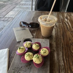 Deviled eggs and iced flat brown coffee.