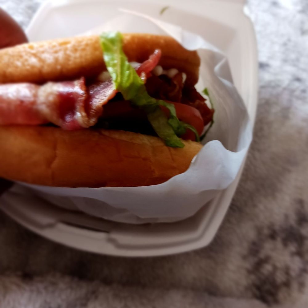 Burger Box - a hand holding a sandwich in a styrofoam container - Burgers Near Me - Bedford, Texas Burger Box - a hand holding a sandwich in a styrofoam container - Burgers Near Me - Bedford, Texas