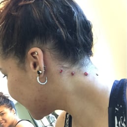 Nape piercing done byJoey Prixx. 4 microdermals.