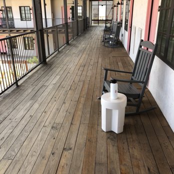 Texican Court - The nice decking around your room with ceiling fans and rocking chairs. Nice breeze in the evening because it's open on all sides. - Hotels Near Me - Irving, Texas Texican Court - The nice decking around your room with ceiling fans and rocking chairs. Nice breeze in the evening because it's open on all sides. - Hotels Near Me - Irving, Texas