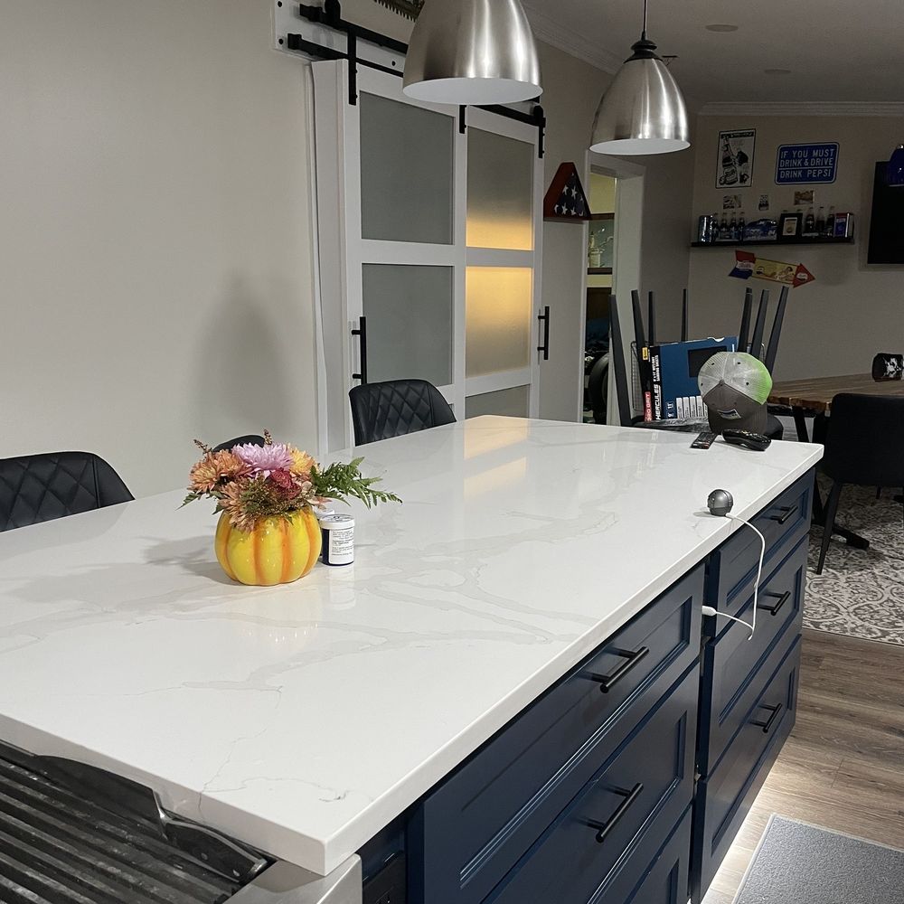 Affordable Granite - a kitchen island with a sink and a grill - Countertop Installation Near Me - Lakeland, Florida