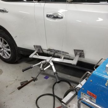 AJ Auto Paints - Pulling out a dent on a door. - Body Shops Near Me - Ajax, Ontario