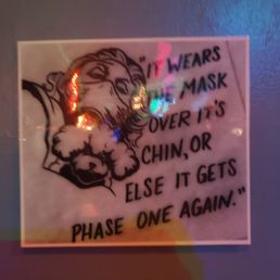 a sign on the wall of a bar a sign on the wall of a bar