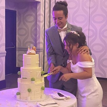 Roxy's Cake Studio - a bride and groom cutting their wedding cake - Desserts Near Me - Albuquerque, New Mexico