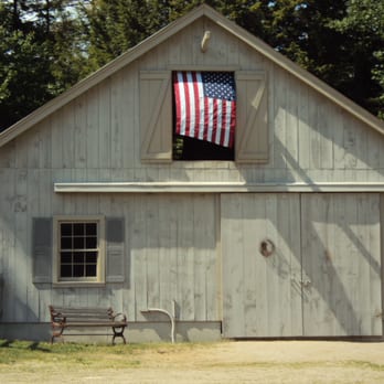 RW Drew Construction - a barn with an american flag hanging from the roof - General Contractors Near Me - Lovell, Maine RW Drew Construction - a barn with an american flag hanging from the roof - General Contractors Near Me - Lovell, Maine