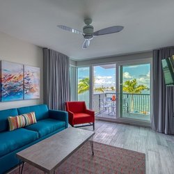 FUSION Resort - Modern waterfront suite living room with balcony access and intracoastal water views at FUSION Resort in Treasure Island, Flo...