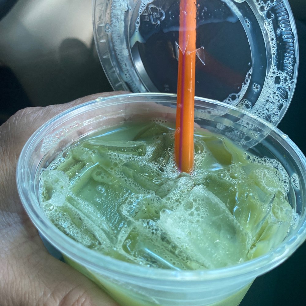 Dunkin' - a hand holding a plastic cup with a drink in it - Donuts Near Me - Chambersburg, Pennsylvania Dunkin' - a hand holding a plastic cup with a drink in it - Donuts Near Me - Chambersburg, Pennsylvania