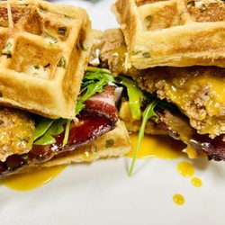 4 Chicken & Waffles - C & W Sandwich - Scallion filled waffle with fried chicken, arugula, tomato, maple bacon and maple mustard