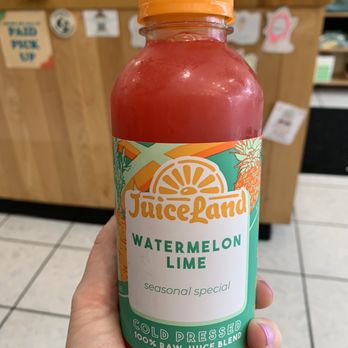 JuiceLand - a hand holding a bottle of watermelon - Juice Bars & Smoothies Near Me - Austin, Texas
