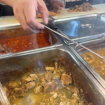Uruapan Taco - Chile verde pork is what you see in the front and in the back you could see the two burritos being made. - Mexican Near Me - Compton, California Uruapan Taco - Chile verde pork is what you see in the front and in the back you could see the two burritos being made. - Mexican Near Me - Compton, California
