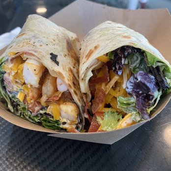 Freshfit Cafe - Bacon shrimp wrap with avocado ranch, lettuce, tomato, and cheese, on a gluten free wrap.  10/10, would recommend.  [GF] - Juice Bars & Smoothies Near Me - Nags Head, North Carolina