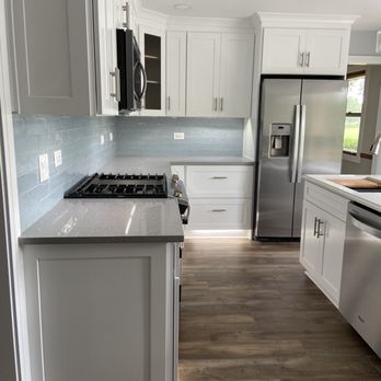 A-Top Remodeling - a clean kitchen with white cabinets and stainless steel appliances - Cabinetry Near Me - Downers Grove, Illinois
