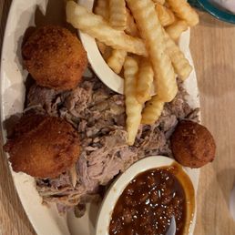 BBQ pulled pork plate, fries, baked beans, and hush puppies BBQ pulled pork plate, fries, baked beans, and hush puppies