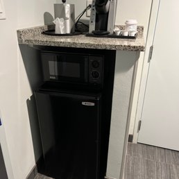 Kerrigan coffee maker with three green mountain cups, mini fridge, and microwave. Kerrigan coffee maker with three green mountain cups, mini fridge, and microwave.