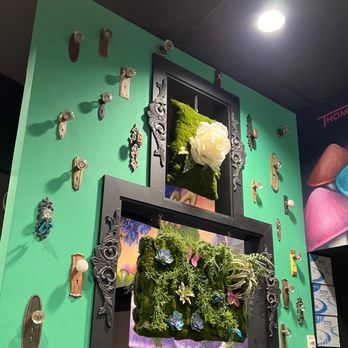 Mellow Mushroom Columbus - a green wall with a moss covered mirror - Pizza Near Me - Columbus, Georgia Mellow Mushroom Columbus - a green wall with a moss covered mirror - Pizza Near Me - Columbus, Georgia